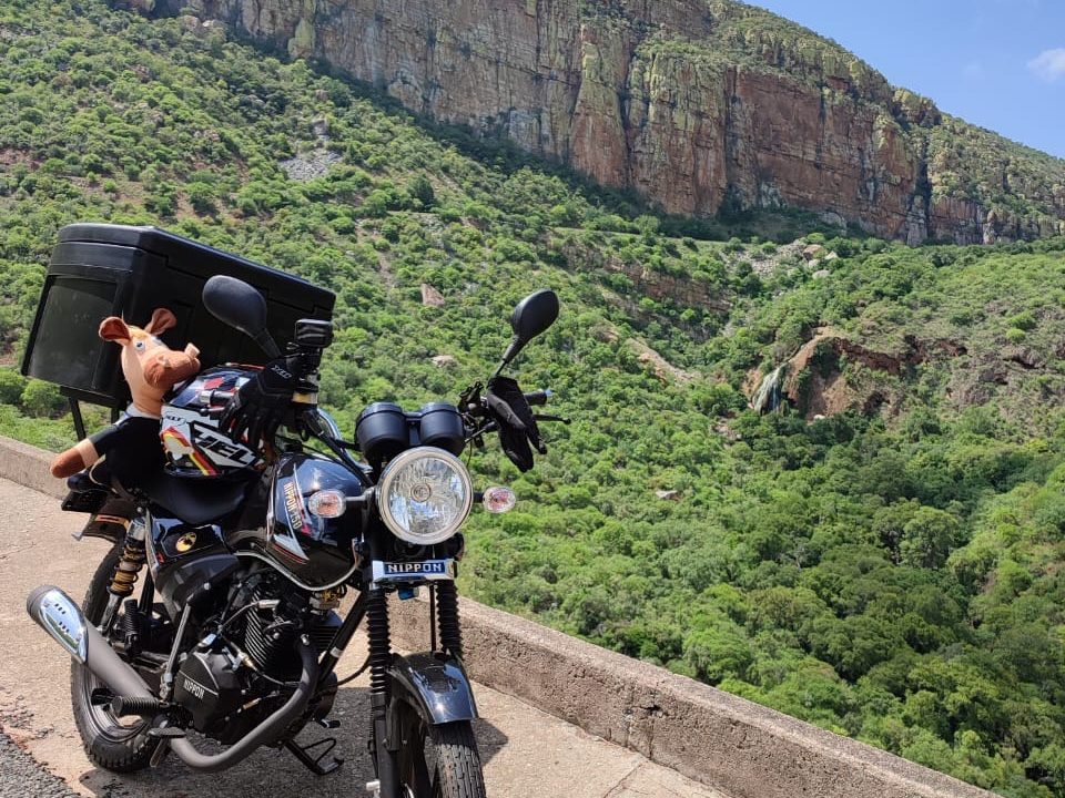 The Nippon 150 above a green mountain valley